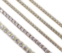 Five silver cubic zirconia line bracelets,