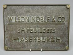 Rectangular brass plaque, lettered in relief 'Wilson Noble & Co. Shipbuilders.