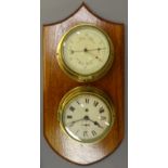 Sestrel brass cased Aneroid Barometer, circular cream dial with red pointer and a bulkhead clock,