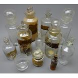 Eleven Victorian and later apothecary's clear glass bottles with stoppers, various sizes,