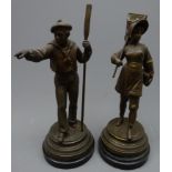 Pair patinated spelter figures of a sailor with oar and fisher girl with net on ebonised circular
