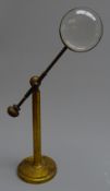 Late 19th/early 20th century gilt brass magnifying glass with convex lens on telescopic adjustable