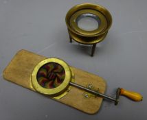 Victorian chromotropic mechanical magic lantern slide L15cm and a maritime small brass chart table
