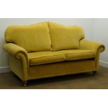 Three seat sofa upholstered in a golden fabric,