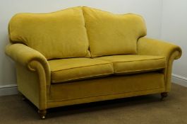 Three seat sofa upholstered in a golden fabric,