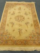 Chinese beige ground rug, central floral medallion, field of classical style urns,