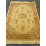 Chinese beige ground rug, central floral medallion, field of classical style urns,