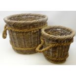 Two graduating wicker log baskets with rope work handles,