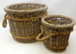 Two graduating wicker log baskets with rope work handles,