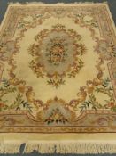 Chinese beige ground woollen rug carpet, central medallion, repeating floral border,