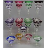 Set of twelve Bohemian Harlequin overlay flash cut claret glasses on tall faceted stems and a set