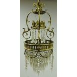 Gilt brass Regency style chandelier cast with floral swags and scroll frame with faceted glass