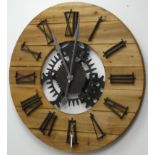 Large circular planked pine wall clock with Roman numerals,