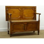 Early 20th century oak monks bench, hinged lid, panelled sides, square supports, W112cm, H94cm,