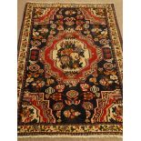 Eastern hand knotted blue ground rug, stepped central medallion, geometric field, repeating border,