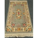 Chinese green ground rug, central medallion, repeating border,