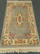 Chinese green ground rug, central medallion, repeating border,