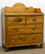 Early 20th century waxed pine washstand, raised shaped back and sides,