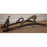 Wooden framed Dromedary saddle with pierced metal decoration, on curved supports, L132cm,