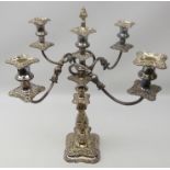 Old Sheffield plate five light candelabra, scroll arms, foliate embossed stem on shaped square base,