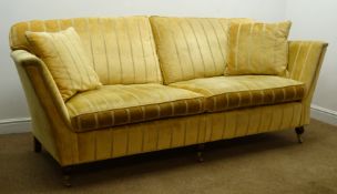 Duresta Ruskin style Grande sofa upholstered in pale gold fabric, turned supports on castors,