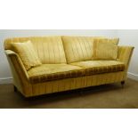 Duresta Ruskin style Grande sofa upholstered in pale gold fabric, turned supports on castors,