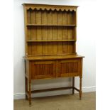 Early 20th century oak dresser, projecting cornice, two plate rack above two cupboard doors,