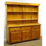 Pine kitchen dresser, shaped cornice, two plate racks, three drawers and three cupboard doors,