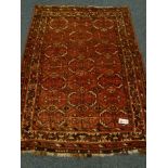 Bokhara style red ground rug, geometric patterned field, repeating border,