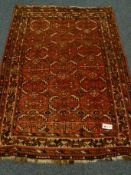 Bokhara style red ground rug, geometric patterned field, repeating border,