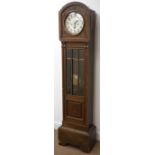 20th century arched top oak long case clock, silvered Arabic dial with triple train movement,