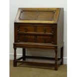 Early 20th century oak bureau, fall front enclosing fitted interior, two drawers, turned supports,