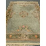 Chinese green ground rug carpet, central floral medallion, repeating border,