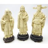 Three Chinese Ivory style resin models of three Sages,