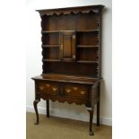 Early 20th century oak dresser, projecting cornice, four plate racks with central cupboard,