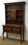 Early 20th century oak dresser, projecting cornice, four plate racks with central cupboard,