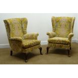 Pair Parker Knoll wingback armchairs, upholstered in a floral fabric, cabriole legs,