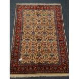 Araak beige and red ground rug, repeating border floral field,
