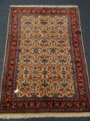 Araak beige and red ground rug, repeating border floral field,
