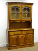 Early 20th century style oak finish dresser, projecting cornice above two glazed doors, two drawres,