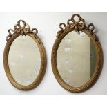 Pair 19th century gilt gesso oval mirrors, reeded frame surmounted by a ribbon tied crest,