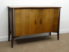 Mid 20th century teak side board, shaped top, two doors enclosing fitted maple interior,