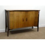 Mid 20th century teak side board, shaped top, two doors enclosing fitted maple interior,