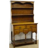 Early 20th century medium oak dresser, projecting cornice above two shelf plate rack,