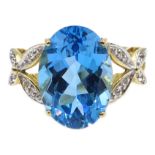 9ct gold blue topaz ring, with diamond set cross over shoulders,