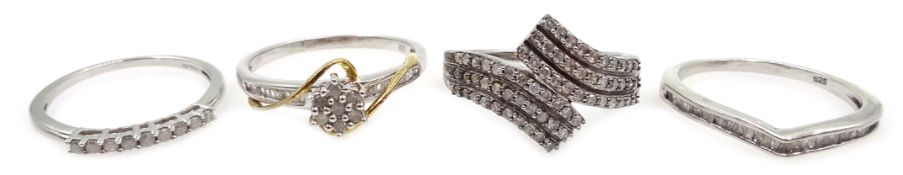 Diamond set silver cross over ring, and three diamond set silver rings,