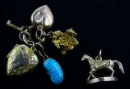 9ct gold horse on plinth, nugget, lockets and kidney bean charms Condition Report 8.
