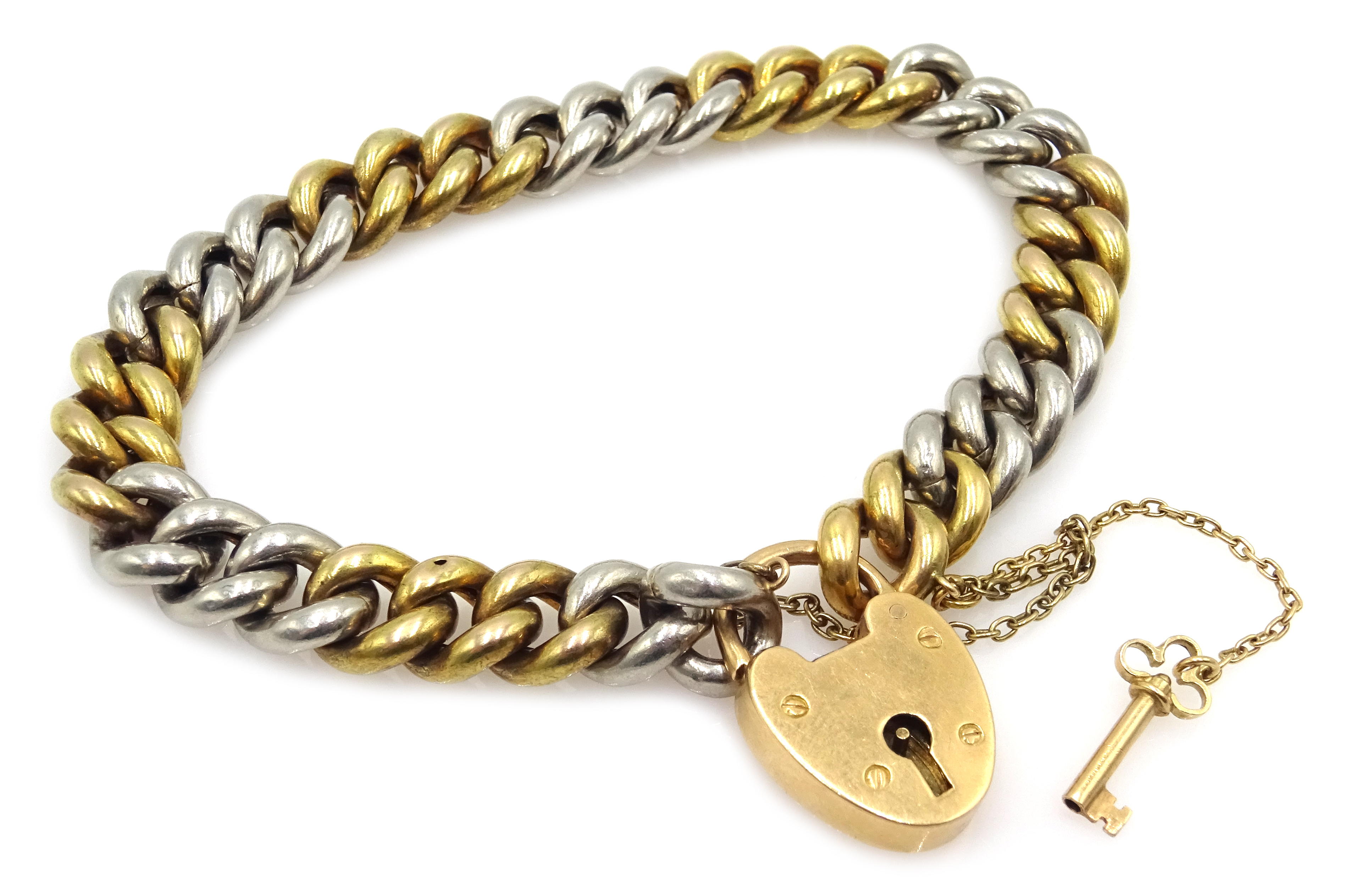 Platinum and 18ct gold (tested) curb chain bracelet with key and padlock, approx 33.