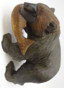 Black Forest style carved model of a bear with salmon catch,