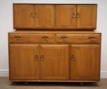 Ercol Elm side cabinet, raised back with four cupboard doors above two drawers,